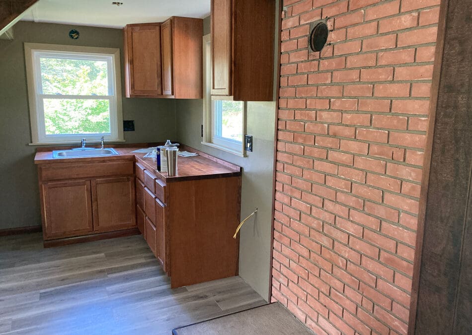 Camp-Kitchen-stove-area-cabinets-floor-walls-windows